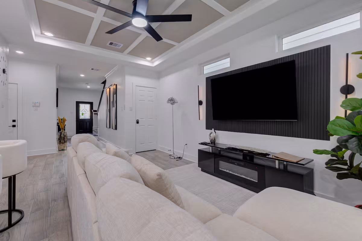 Living room with deep sectional seating and wall-mounted television